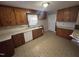 Spacious kitchen with wood cabinets, ample counter space, and a white dishwasher at 1704 Southgate St, Durham, NC 27703
