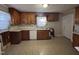 Traditional kitchen with tile floors, wooden cabinets, and ample counter space at 1704 Southgate St, Durham, NC 27703