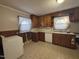 Efficient kitchen with wooden cabinets, tile floors, and essential appliances at 1704 Southgate St, Durham, NC 27703