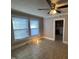 Well-lit room with tile floor and natural light from two windows at 1704 Southgate St, Durham, NC 27703