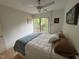 Bedroom featuring a large window with a view, neutral walls, and a ceiling fan at 1708 Quail Ridge Rd, Raleigh, NC 27609
