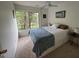 Bedroom featuring a large window with a view, neutral walls, and a ceiling fan at 1708 Quail Ridge Rd, Raleigh, NC 27609