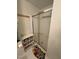 Bathroom shower features sliding glass doors, wire storage shelves, and decorative fish rug at 1708 Quail Ridge Rd, Raleigh, NC 27609