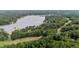 Lush real estate location shown with a nearby lake and surrounded by an expanse of trees and wooded area at 174 Woodwedge Way, Sanford, NC 27332