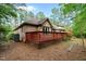The brick home features a spacious backyard with a wooden deck, perfect for outdoor gatherings and relaxation at 174 Woodwedge Way, Sanford, NC 27332