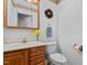 Bathroom featuring a vanity with decorative hardware, a toilet, and a decorative wreath at 174 Woodwedge Way, Sanford, NC 27332