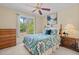 Bedroom with nature views outside the window, a ceiling fan, and neutral colored walls at 174 Woodwedge Way, Sanford, NC 27332