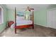 Relaxing primary bedroom featuring a four-poster bed, dresser, and soft carpeting at 174 Woodwedge Way, Sanford, NC 27332