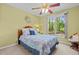 Bedroom with a window overlooking trees, a ceiling fan, and neutral wall color at 174 Woodwedge Way, Sanford, NC 27332