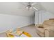 Upstairs bonus room with carpeting, ceiling fan, and comfortable seating at 174 Woodwedge Way, Sanford, NC 27332