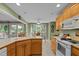 Bright kitchen with wooden cabinets, white appliances, and view to the outdoor deck at 174 Woodwedge Way, Sanford, NC 27332