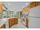 Functional kitchen with light wood cabinets, white appliances, and an adjoining dining area at 174 Woodwedge Way, Sanford, NC 27332