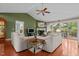 Comfortable living room with a fireplace, ceiling fan, and access to the outdoor deck, bathed in natural light at 174 Woodwedge Way, Sanford, NC 27332