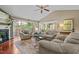 Inviting living room with vaulted ceiling, plush seating, and sliding glass doors opening to a deck at 174 Woodwedge Way, Sanford, NC 27332