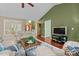 Well-lit living area featuring hardwood floors, comfortable couches, and an open view to the dining space at 174 Woodwedge Way, Sanford, NC 27332