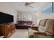 Living room with a brown leather sofa, recliner, ceiling fan and TV console at 174 Woodwedge Way, Sanford, NC 27332