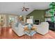 Spacious living room with hardwood floors, comfortable seating, fireplace, and a view into the dining area at 174 Woodwedge Way, Sanford, NC 27332