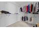 Bright walk-in closet with shelving, hanging rods, and carpeted floor at 174 Woodwedge Way, Sanford, NC 27332