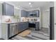 Updated kitchen with stainless steel appliances, modern backsplash, and stylish flooring at 194 Catskill Ct, Burlington, NC 27217