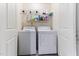Convenient laundry room with washer, dryer, and shelving for storage at 194 Catskill Ct, Burlington, NC 27217