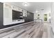 Modern living area with a built-in entertainment center and sleek flooring at 194 Catskill Ct, Burlington, NC 27217