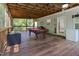 Covered deck featuring a pool table and outdoor living space for entertainment at 194 Catskill Ct, Burlington, NC 27217