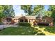 Backyard view of brick home showing fenced backyard at 1973 Elon Ossipee Rd, Elon, NC 27244