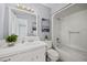 Bathroom featuring a white vanity, rectangular mirror, and a tub with shower at 1973 Elon Ossipee Rd, Elon, NC 27244