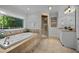 Luxurious bathroom featuring a soaking tub, walk-in shower, and elegant fixtures at 1973 Elon Ossipee Rd, Elon, NC 27244