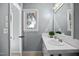 Bright bathroom with a white tiled countertop and light gray walls at 1973 Elon Ossipee Rd, Elon, NC 27244