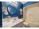 Bathroom featuring a white vanity, round mirror, and a tub with shower at 1973 Elon Ossipee Rd, Elon, NC 27244