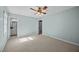 Bedroom featuring light blue walls, carpet floors, and a view to the ensuite bathroom at 1973 Elon Ossipee Rd, Elon, NC 27244