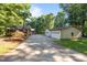 Long concrete driveway to the house and detached garage with three car garage bays at 1973 Elon Ossipee Rd, Elon, NC 27244