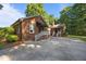 Brick home with a white staircase and awning, showcasing the side entrance and driveway at 1973 Elon Ossipee Rd, Elon, NC 27244