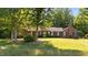 Lovely brick home featuring a spacious front yard with beautiful, mature trees at 1973 Elon Ossipee Rd, Elon, NC 27244