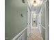 Hallway with tile floors, green walls, and doors on both sides at 1973 Elon Ossipee Rd, Elon, NC 27244