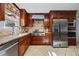 Well-equipped kitchen featuring stainless steel appliances, granite counters, and wood cabinets at 1973 Elon Ossipee Rd, Elon, NC 27244