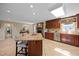 Large kitchen with a granite island and a stone fireplace in the background at 1973 Elon Ossipee Rd, Elon, NC 27244