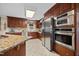 Modern kitchen showcasing stainless steel appliances, custom cabinetry, and a skylight for natural light at 1973 Elon Ossipee Rd, Elon, NC 27244