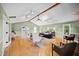 Bright living room featuring hardwood floors, vaulted ceiling, and large windows providing natural light at 1973 Elon Ossipee Rd, Elon, NC 27244