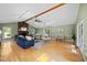 Bright living room featuring hardwood floors, a stone fireplace, and access to the outdoor area at 1973 Elon Ossipee Rd, Elon, NC 27244