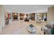 Open concept living room with a stone fireplace, kitchen island, and dining room chandelier at 1973 Elon Ossipee Rd, Elon, NC 27244
