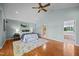 Inviting main bedroom with vaulted ceilings, hardwood floors, plush rug, and ensuite bathroom entrance at 1973 Elon Ossipee Rd, Elon, NC 27244