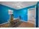 Bright office features blue walls, wood floors, and a decorative wood desk with vases at 1973 Elon Ossipee Rd, Elon, NC 27244