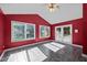 Sunroom with red walls, multiple windows, and access to the outside at 1973 Elon Ossipee Rd, Elon, NC 27244
