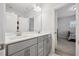 Modern bathroom with double sinks, gray vanity, white countertop, and a large mirror at 2009 Latham Oaks Ave, Wake Forest, NC 27587