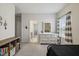 Bright bedroom with neutral walls, gray carpet, and large window with stylish gray and white striped curtains at 2009 Latham Oaks Ave, Wake Forest, NC 27587