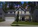 Beautiful two-story home featuring a well-manicured lawn and an attached two-car garage at 2009 Latham Oaks Ave, Wake Forest, NC 27587