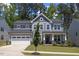 Beautiful two-story home featuring a well-manicured lawn and an attached two-car garage at 2009 Latham Oaks Ave, Wake Forest, NC 27587