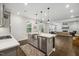 Bright, open kitchen features stainless steel appliances, large island, and seamless flow to the living room at 2009 Latham Oaks Ave, Wake Forest, NC 27587